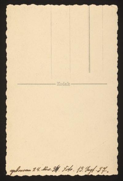 ANNOTATION ON PHOTO (back, handwritten): German: "geboren 24. Nov. 36. Foto. 15. Sept. 37." English: "Born 24 November 1936. Photo [taken] 15 September 1937." Kodak postcard back. Description: Front shows a baby lying on its stomach on a blanket, smiling. The child was approximately 10 months old when the photograph was taken.