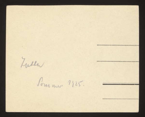 ANNOTATION ON PHOTO (back, handwritten in blue ink): "Trella Sommer 1925." English: "Trella Summer 1925." Description: Front shows a young woman sitting on a rock outdoors, reading or writing, in an oval-framed photograph. She is identified as "Trella."