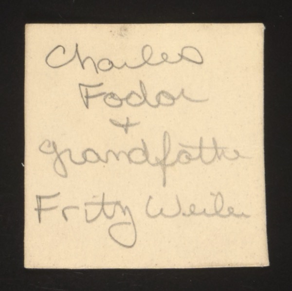 ANNOTATION ON PHOTO (back, handwritten): "Charles Fodor + grandfather Fritz Weiler" IMPORTANT FAMILY CONNECTION: This photograph identifies Fritz Weiler (likely Friedrich Weiler), who is the patriarch of the "Carl and Mina Weiler papers" collection at the USHMM (accession 2004.485.1). "Carl" is likely an Americanization of "Karl" (Fritz's full name may have been Karl Friedrich Weiler, or Fritz may be his father/relative). Charles Fodor appears to be a grandchild of Fritz Weiler, possibly through a daughter who married someone named Fodor (a Hungarian surname). Description: Front shows an elderly man (Fritz Weiler) with a younger man or boy (Charles Fodor).